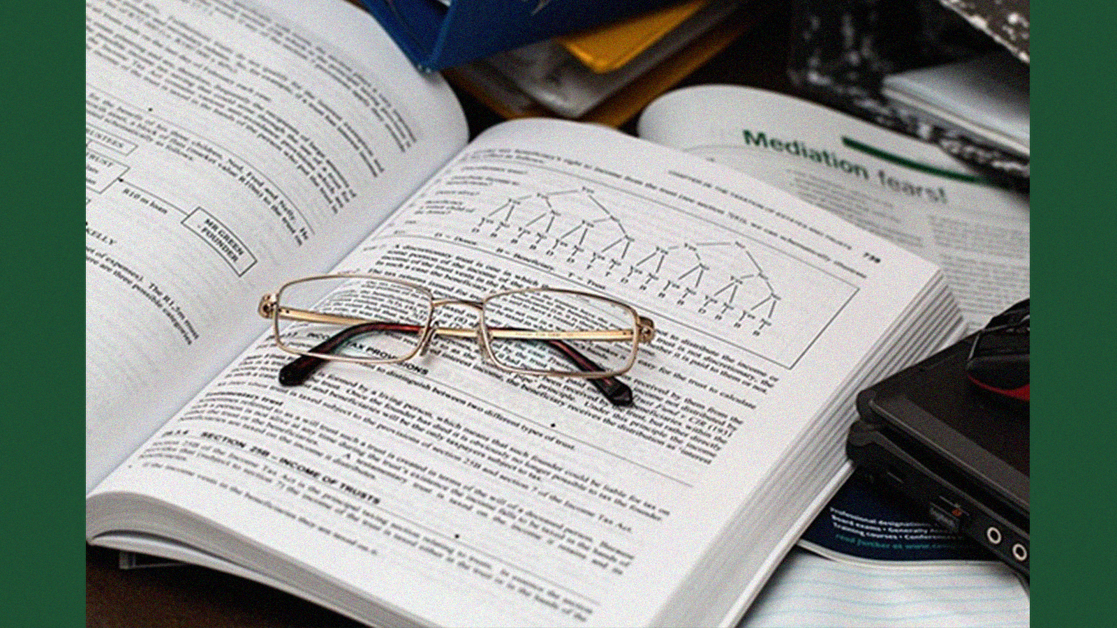 pair of glasses lying on a finance book