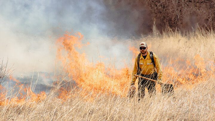 Wyatt Koehler carries out a prescribed fire in March 2025 in his work at the Spring Creek Prairie Audubon Center. Photo by Brady Karg/Audubon